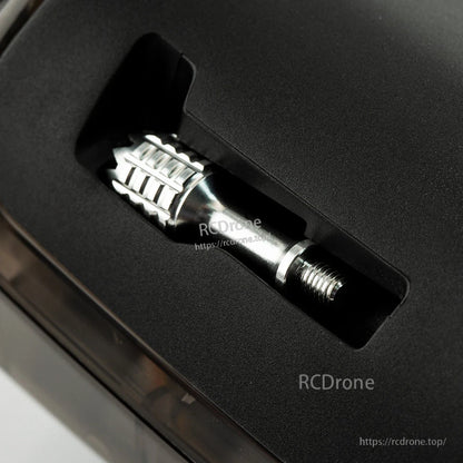 Gimbal stick stored in the radio body slot, showing threaded end and metal grip section