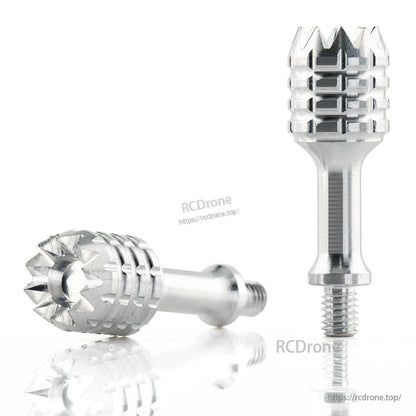 Two metal gimbal sticks on white surface, one upright and one lying down to show grip pattern
