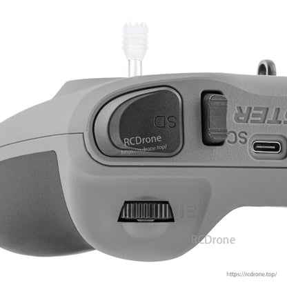 Close-up of top shoulder area showing SD label, power switch, USB-C port, and scroll wheel control