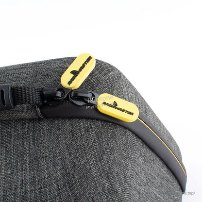Close-up of dual zipper pulls on grey case with yellow Radiomaster zipper tabs