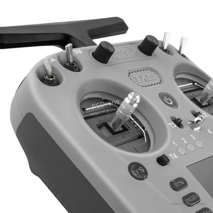Close-up of TX15 top-left controls showing switch cluster and left gimbal stick detail