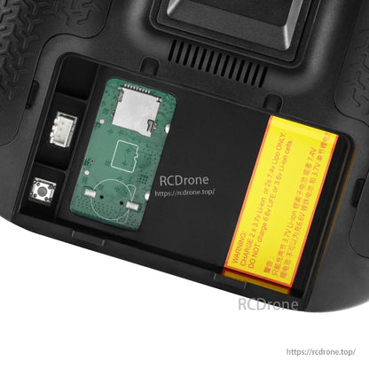 Rear battery bay compartment showing internal board area and warning label inside TX15 Max