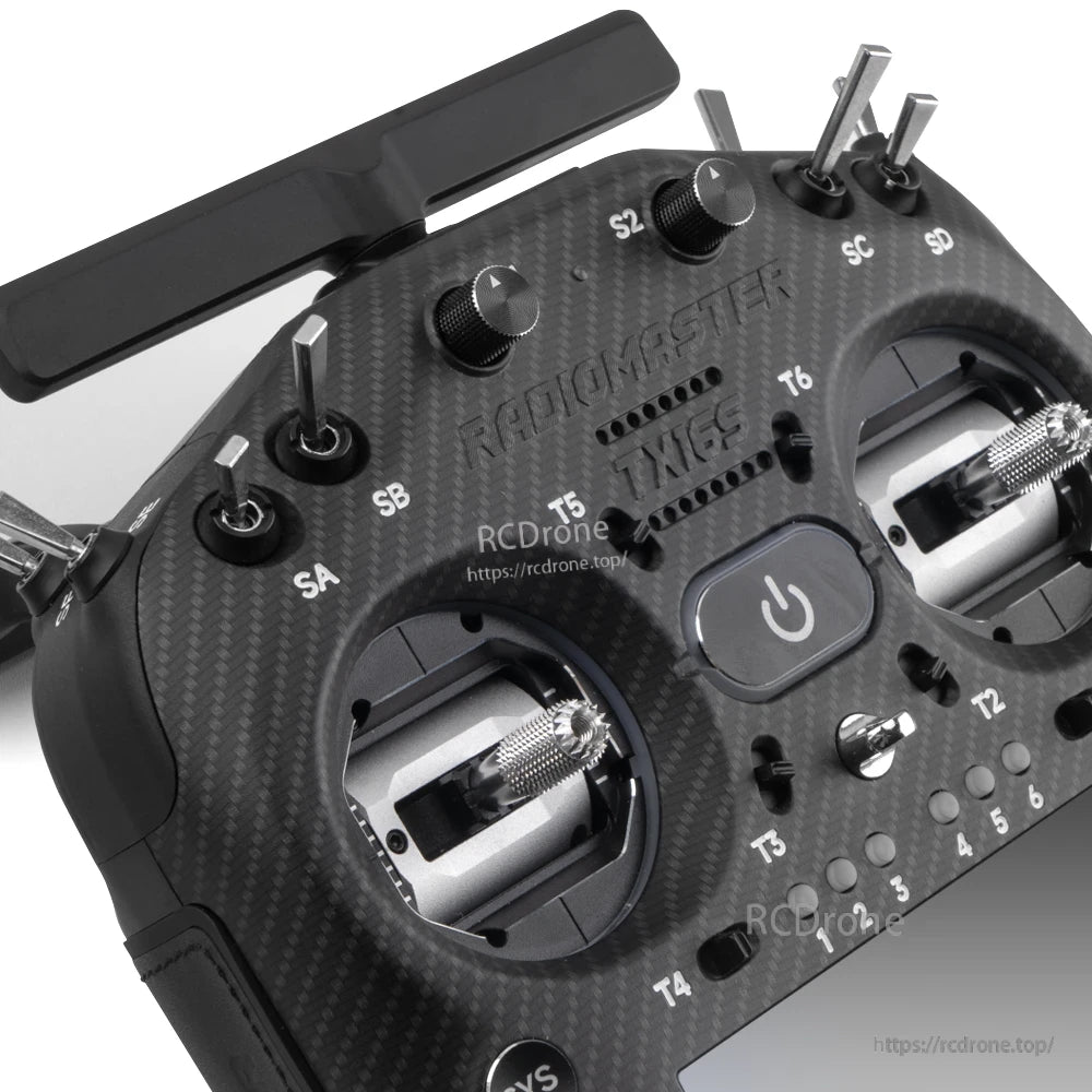 Close-up of TX16S MK3 MAX top panel showing switches, knobs, antenna mount, and power button