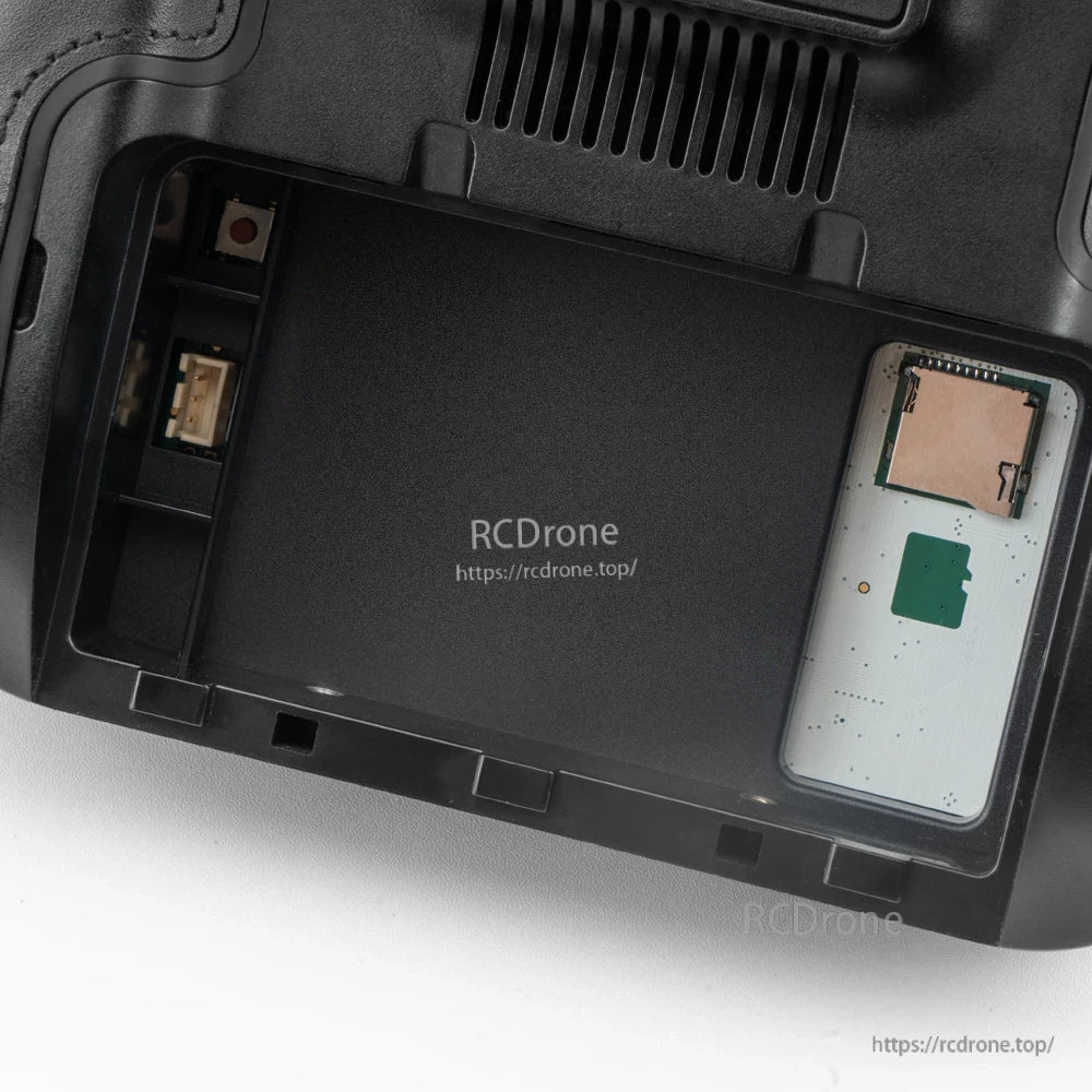 Rear battery compartment open, showing internal bay and connectors inside TX16S MK3