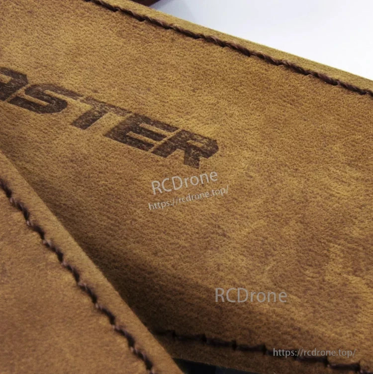 Close-up of brown side grip cover texture and stitching with embossed Master lettering