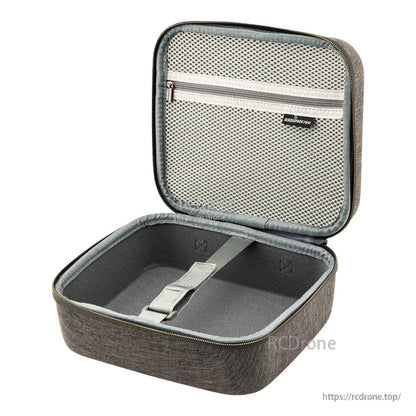 Empty case interior showing padded walls, mesh pocket in lid, and securing strap in base