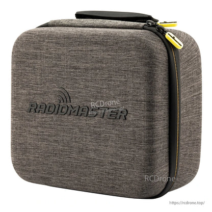 Three-quarter view showing carry case depth, top handle, and yellow zipper pulls