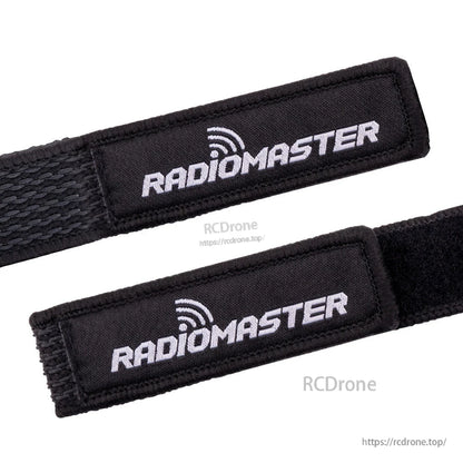 Close-up of RadioMaster logo patch on battery strap with stitched edges and velcro fastening surface