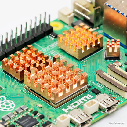 Close-up of copper heatsinks mounted on Raspberry Pi 5 chips near HDMI and GPIO header