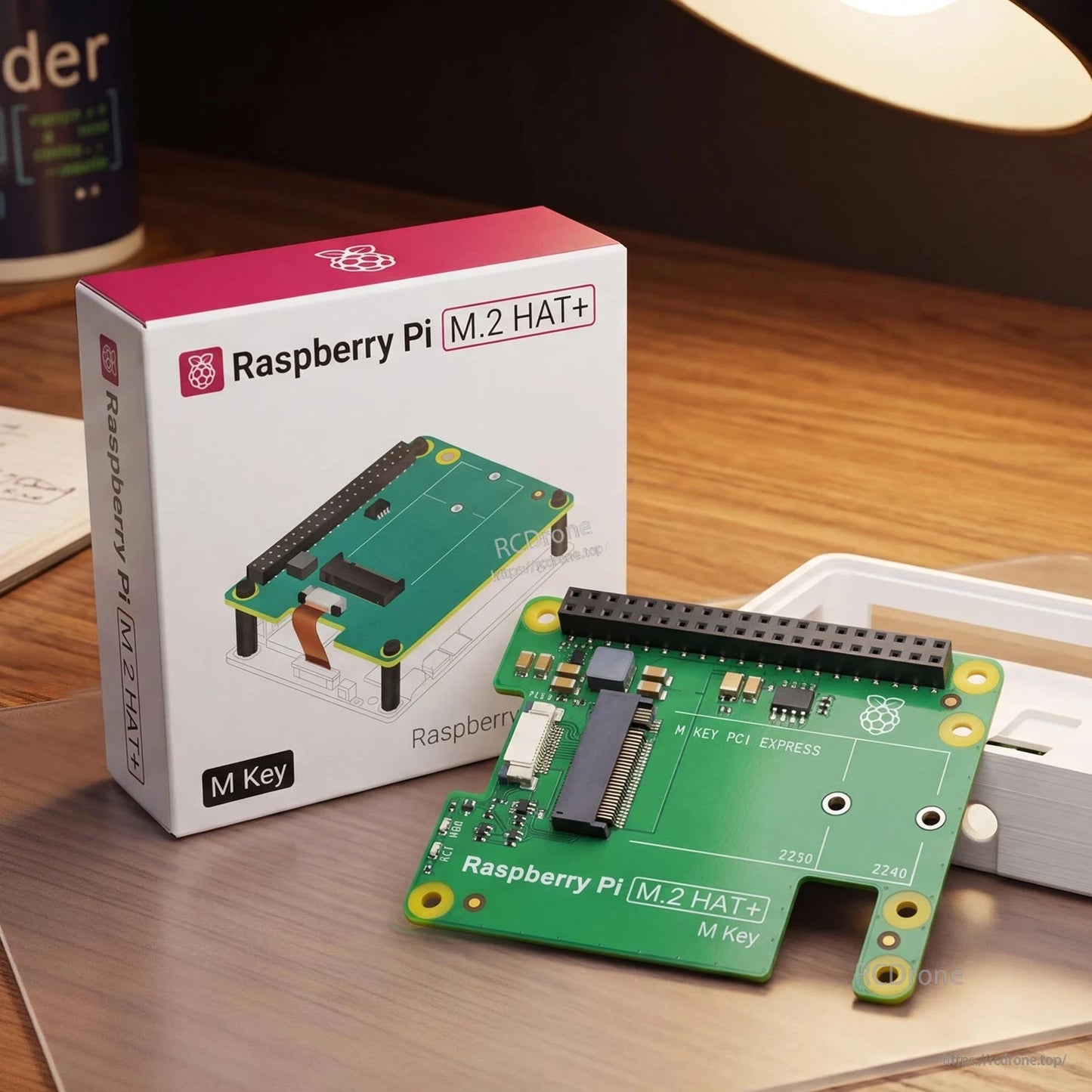 Retail box and Raspberry Pi M.2 HAT+ Standard M Key board on desk setup