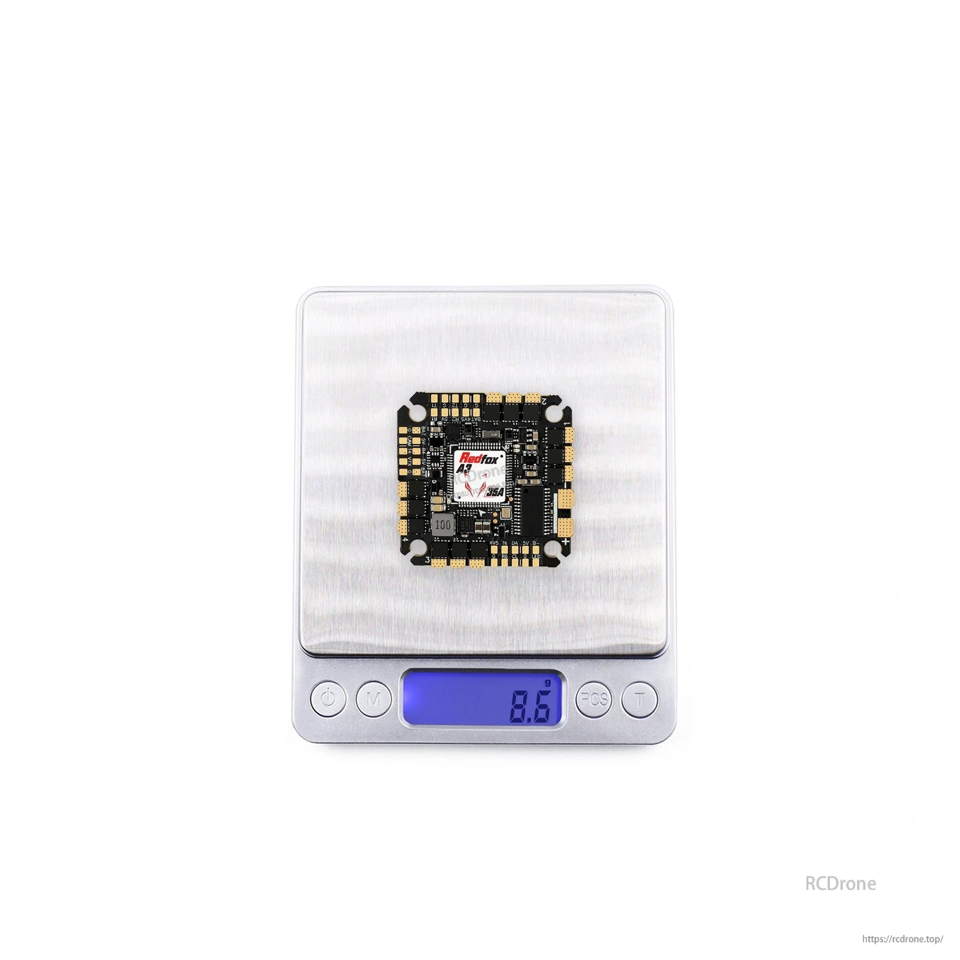 Flight controller on digital scale showing weight reading 8.9 g