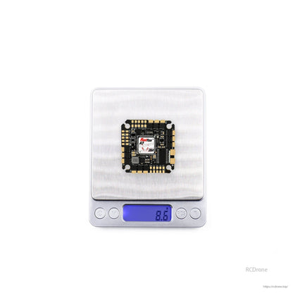 Flight controller on digital scale showing weight reading 8.9 g