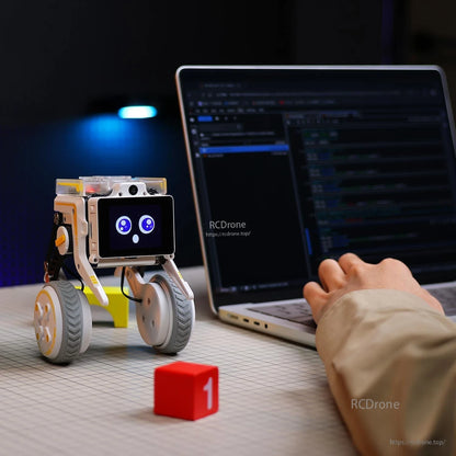 Rider-Pi wheel-legged robot on desk beside laptop, coding/programming use case scene