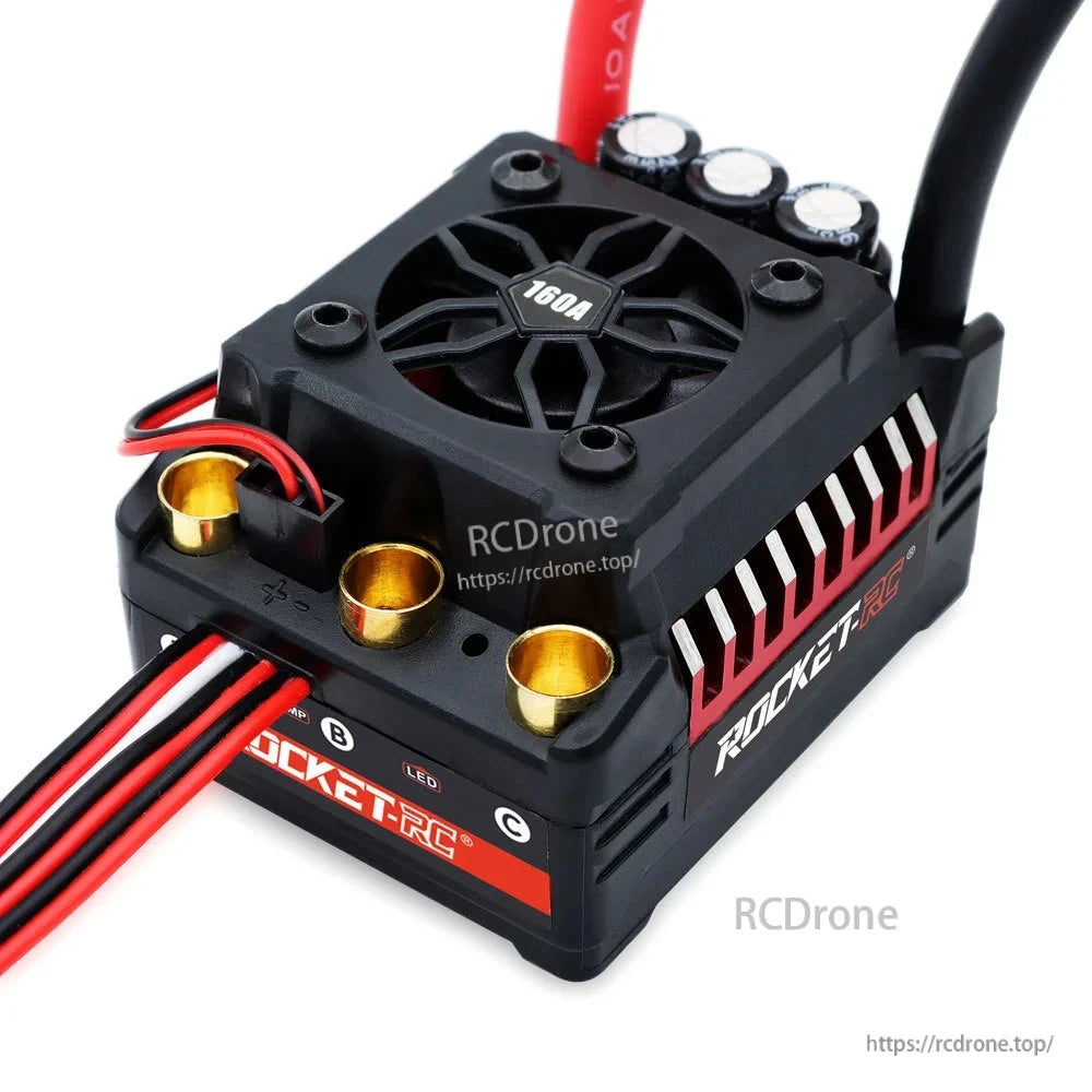 Top close-up of ESC cooling fan, capacitors, motor terminals and signal wire
