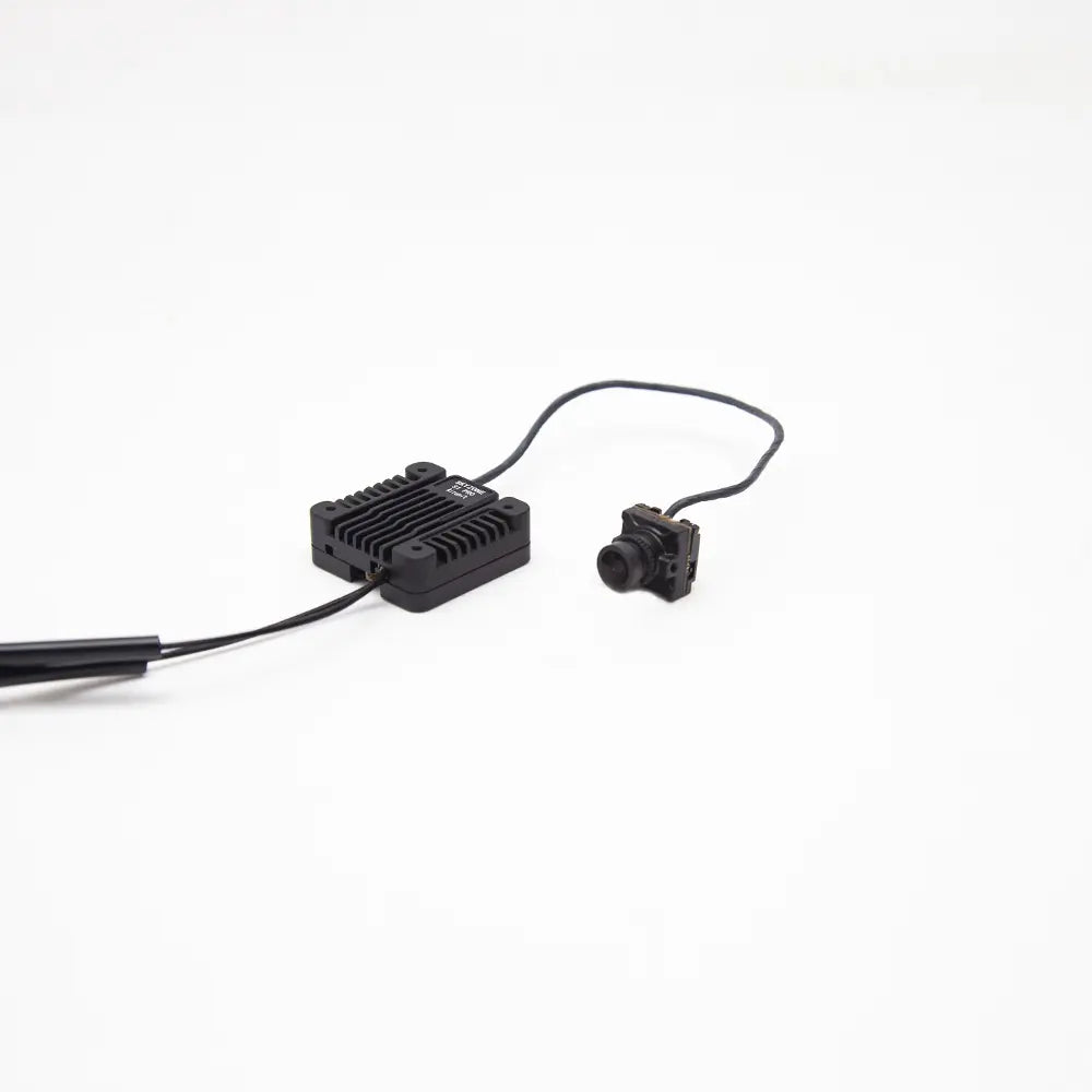 Heatsink VTX module connected to FPV camera and antenna lead, angled side view on white background