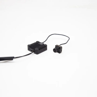Heatsink VTX module connected to FPV camera and antenna lead, angled side view on white background