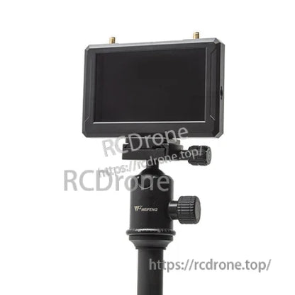 FPV monitor mounted on a tripod head, showing screen side and top antenna connectors