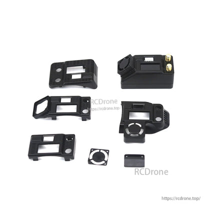 Receiver module set with multiple adapter housings and mounting pieces laid out beside the module