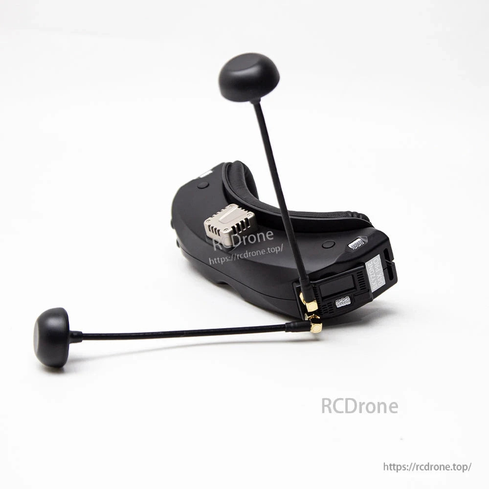 Receiver installed on FPV goggles with two antennas attached, showing side-mounted module fitment