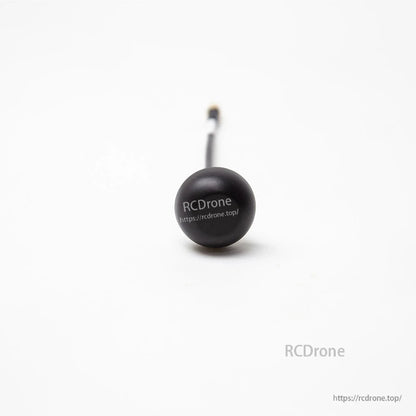 FPV stubby antenna close-up with round cap and attached coax lead