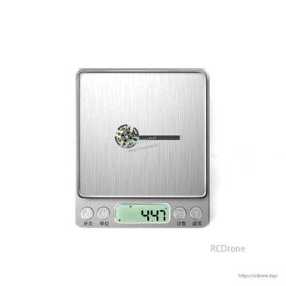 Motor shown on digital scale with display reading 4.47 g for weight reference
