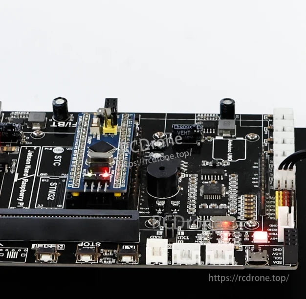 Close-up of DOFBOT-SE controller PCB showing STM32 core module, connector headers, and illuminated indicator LEDs