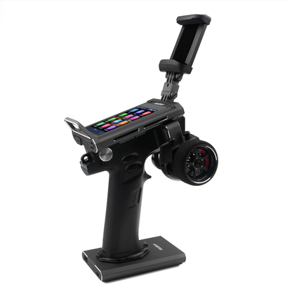 FlySky Noble NB4 Pro+ pistol-grip RC transmitter on stand with color touchscreen and phone holder