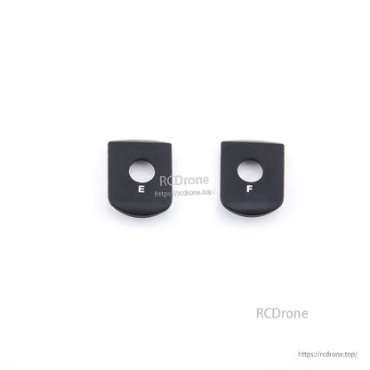 Shoulder Clip set with two black plastic pieces labeled E and F, top view on white background