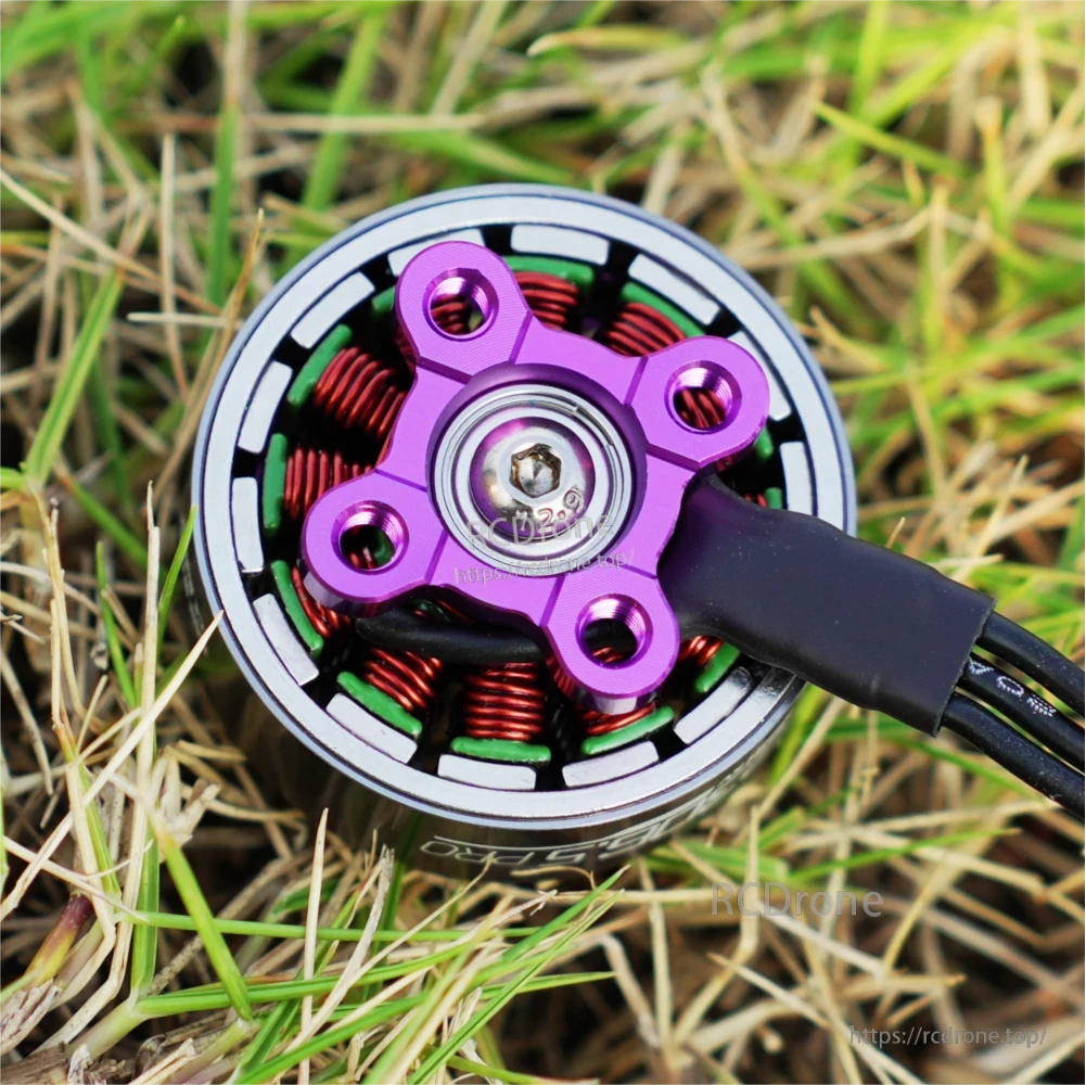 Top view of SpeedyBee BeeStorm FPV drone brushless motor with purple hub, copper windings and attached wires