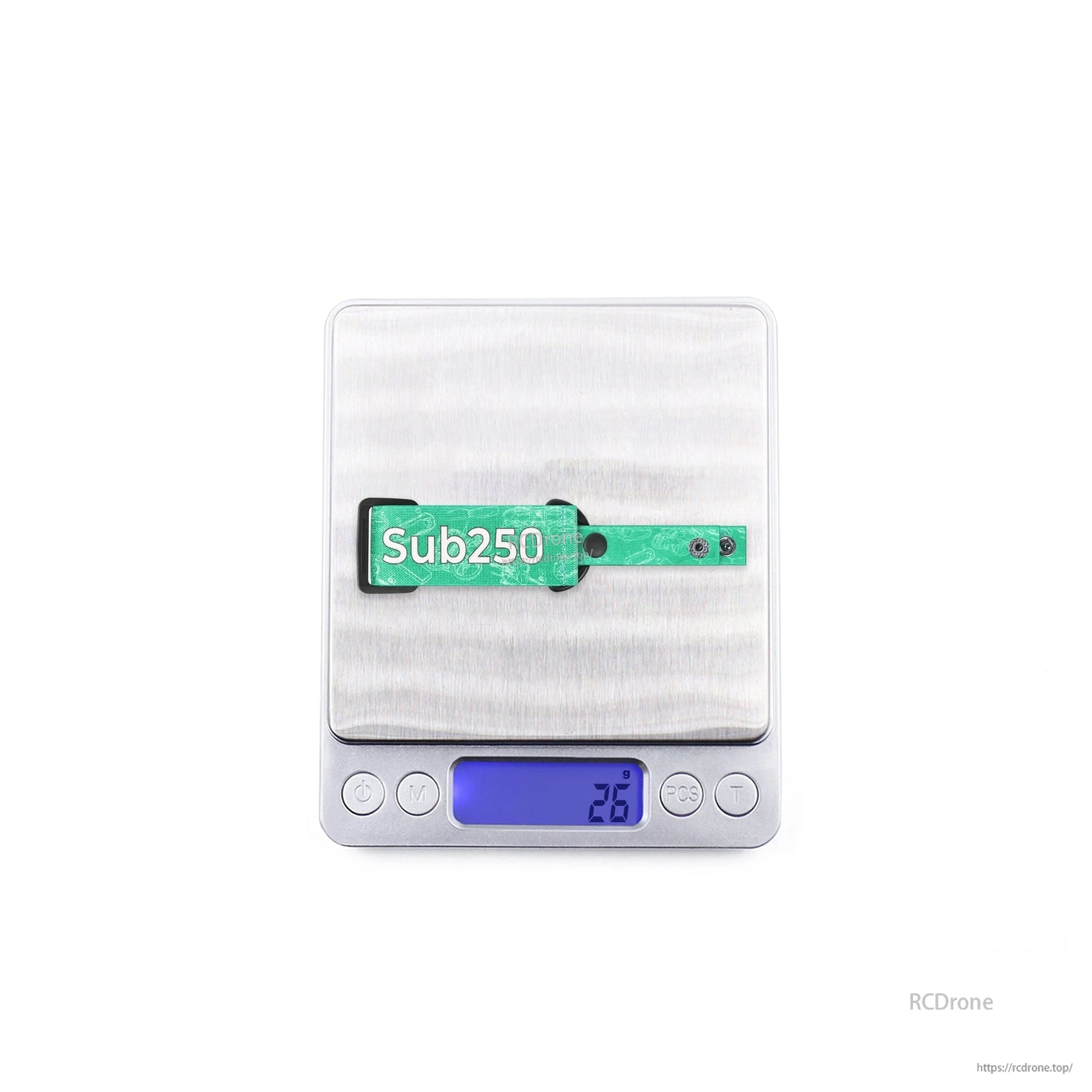 Green Sub250 goggle strap on digital scale showing displayed weight 23.6 g