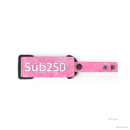 Pink strap close-up showing Sub250 logo patch, nylon weave pattern, and dual snap fasteners