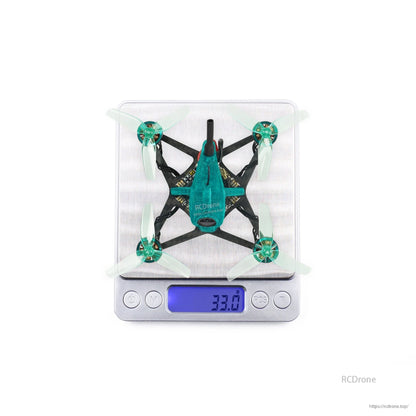 Top view of quadcopter on digital scale displaying 33.0 g weight reading