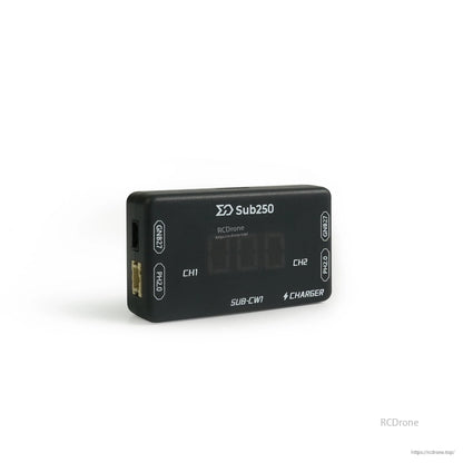 Angled view of charger showing CH1/CH2 display and opposite-side edge with connector opening