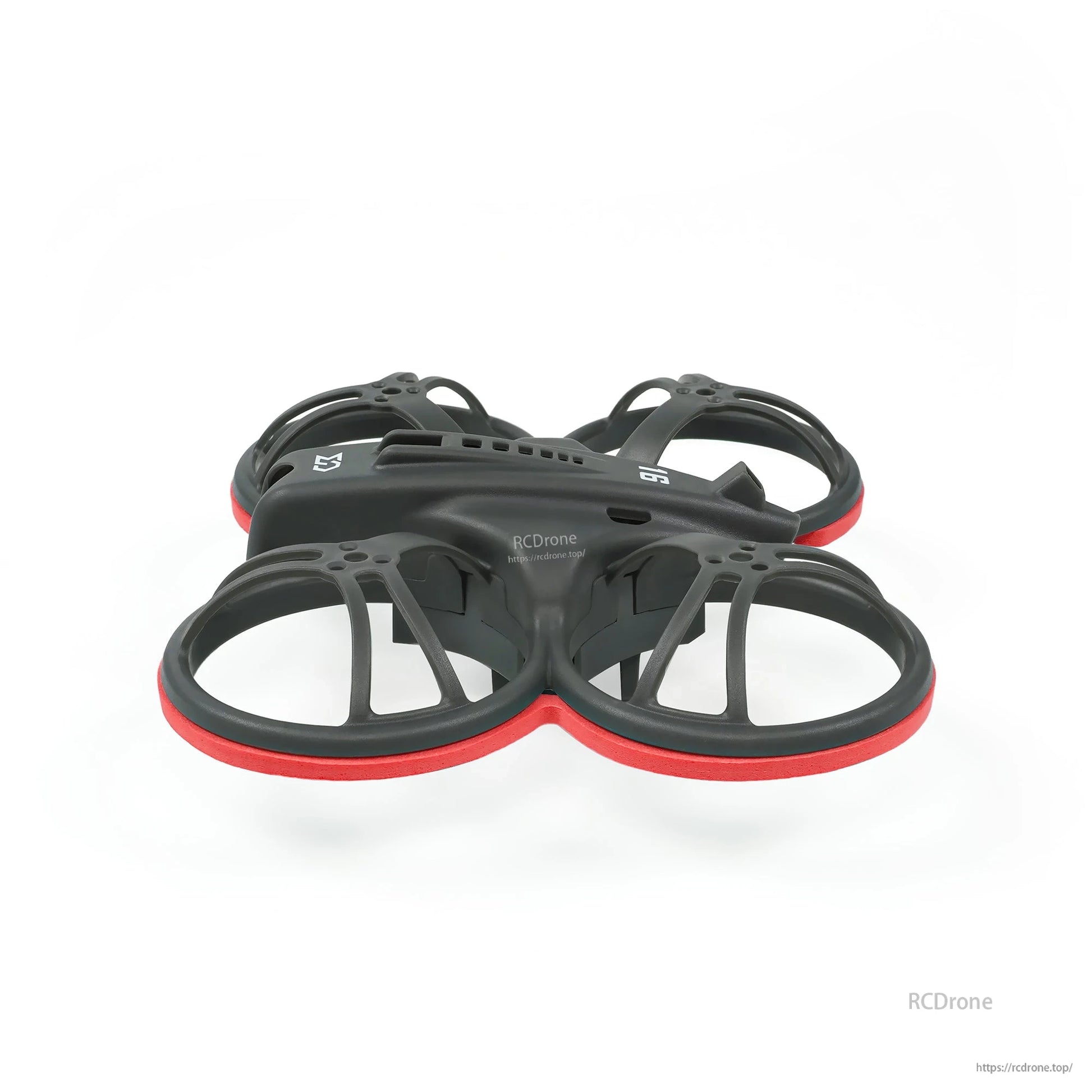 Low side profile of whoop frame with red bumper rings showing duct depth and canopy line