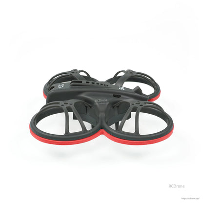 Low side profile of whoop frame with red bumper rings showing duct depth and canopy line
