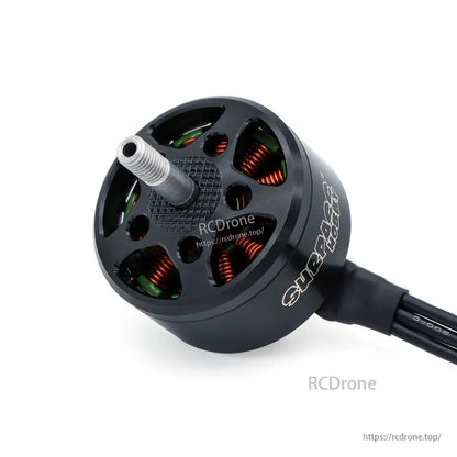 Close-up top view of vented brushless motor bell with visible copper windings and wire lead