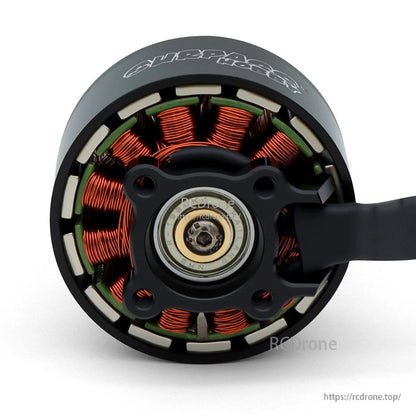 Rear view of brushless motor showing bearing, copper stator windings, and cable exit