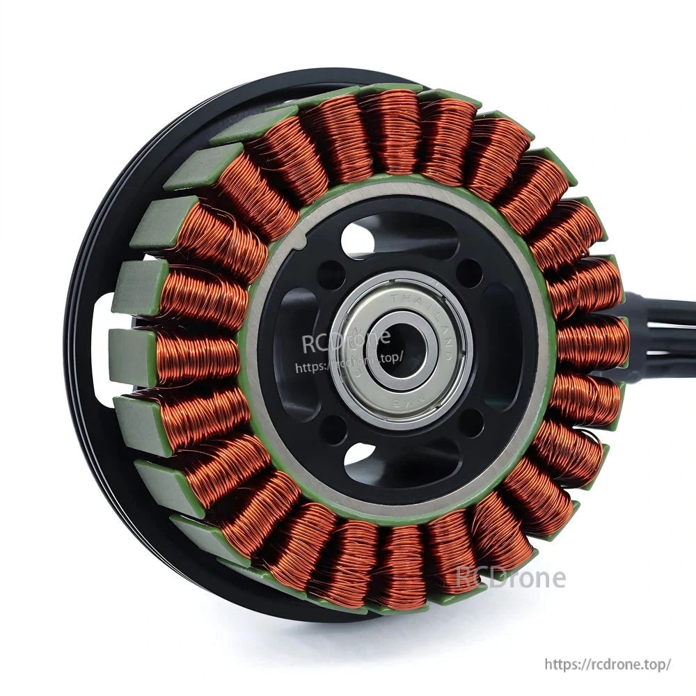 Detailed stator assembly view with copper coils, green insulation, and center bearing