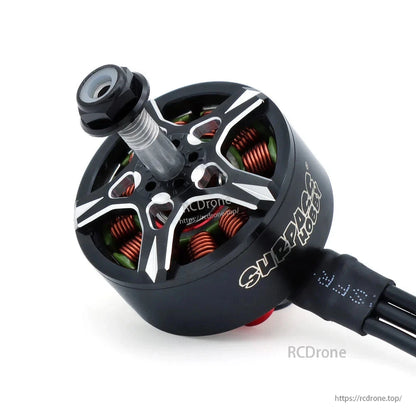 Close-up angled view of Surpass Hobby motor top, copper windings, shaft, and attached cable