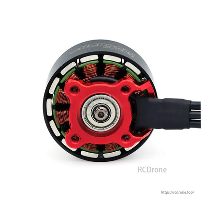 Bottom view showing red mounting base, central bearing, and exposed stator windings on S4218 motor