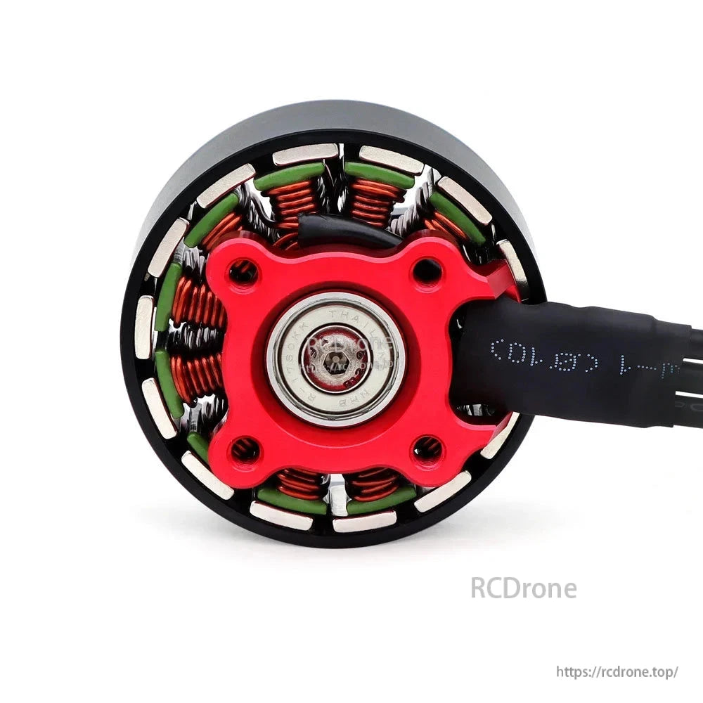 Bottom view of S4320 motor showing red base plate, bearing, and exposed stator windings