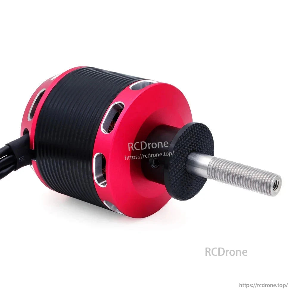 Close-up of threaded motor shaft and front end cap with ventilation slots on red housing