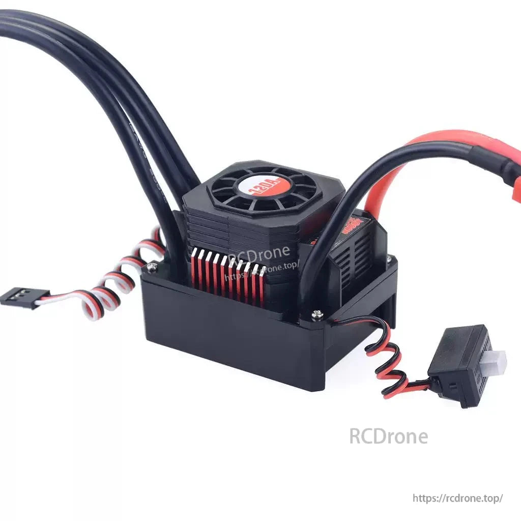 RC car brushless ESC close-up with cooling fan, power leads, and receiver plug