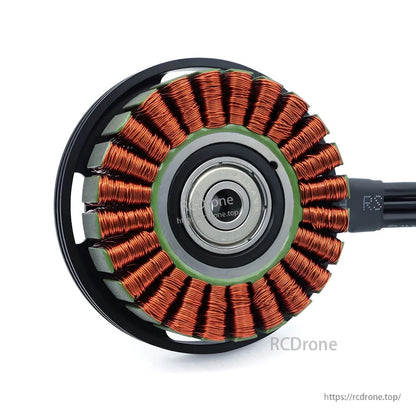 Brushless motor stator close-up showing copper windings and center bearing