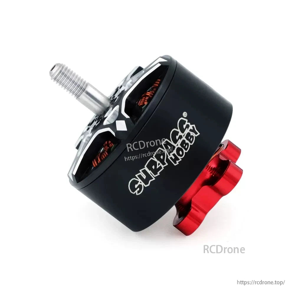 Angled side view of black Surpass Hobby S3110 motor with red mounting base and exposed windings