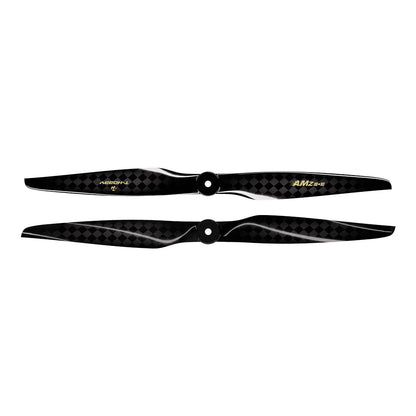 Pair of black carbon fiber AMZ 18x10 RC airplane propellers with checker-weave finish and center mounting holes
