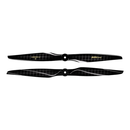 Pair of black carbon fiber AMZ 18x10 RC airplane propellers with checker-weave finish and center mounting holes