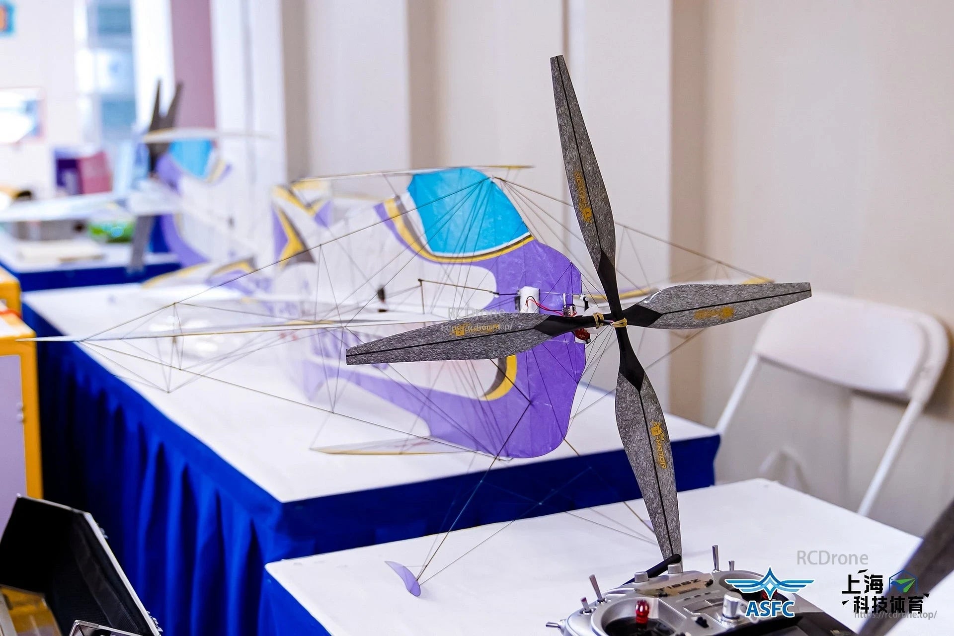 T-Motor carbon-fiber propeller mounted on a lightweight indoor model aircraft with wire frame and fabric wing