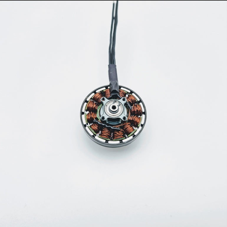 T-Motor brushless drone motor with exposed copper windings and three-wire lead on a white background