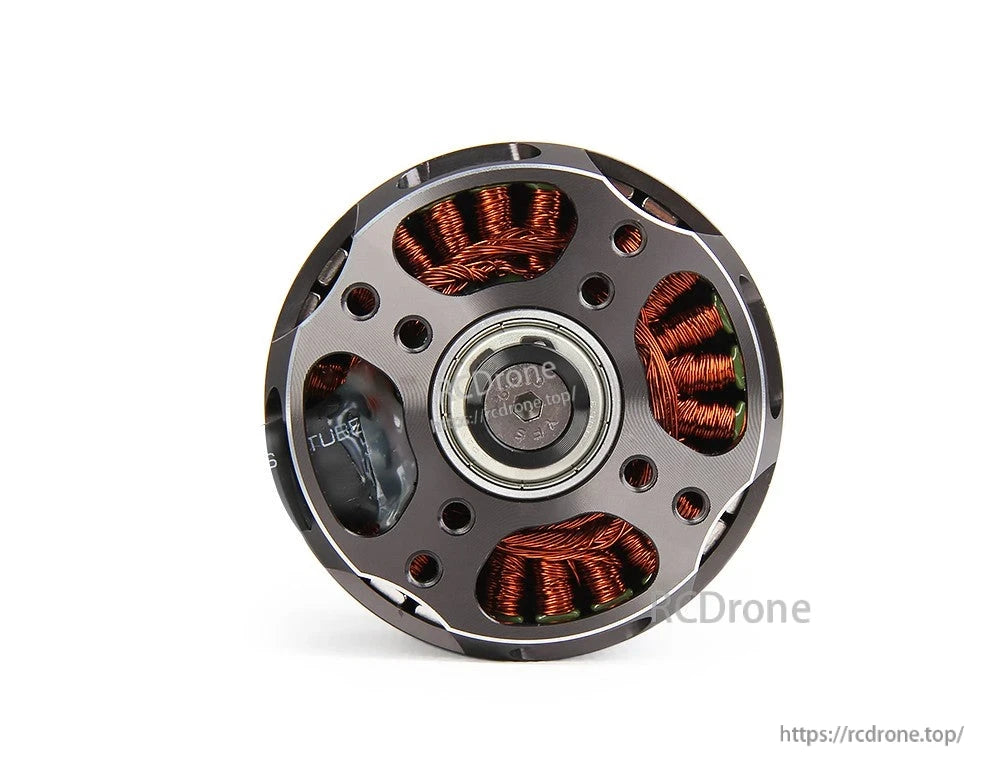 Close-up of a T-Motor brushless outrunner motor base with exposed copper windings, center bearing, and mounting holes